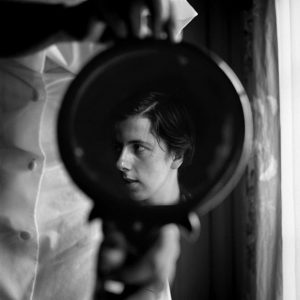 Above: a photograph of Vivian Maier, taken by Maier. 