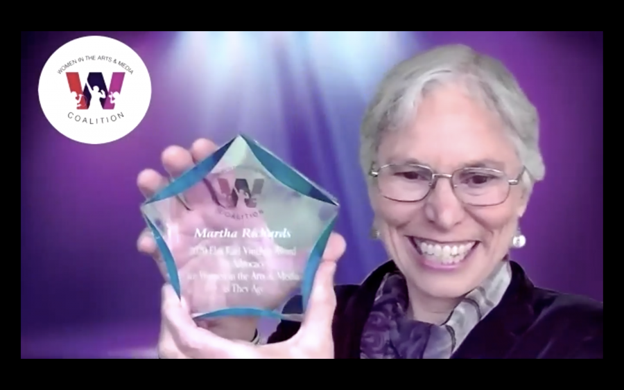 screenshot of Martha Richards holding up the award